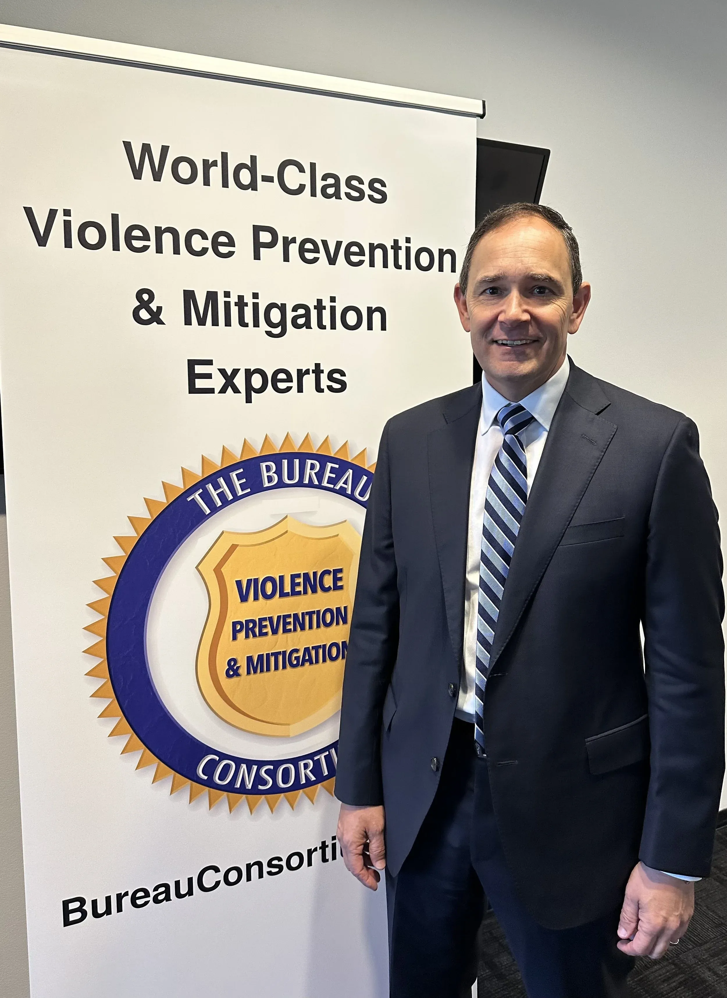 James Hamilton standing beside Bureau Consortium signage